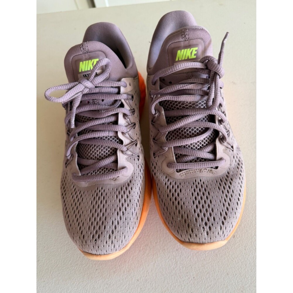 Nike Woman’s Athletic Shoes in Mauve with Orange Sole.Comfortable